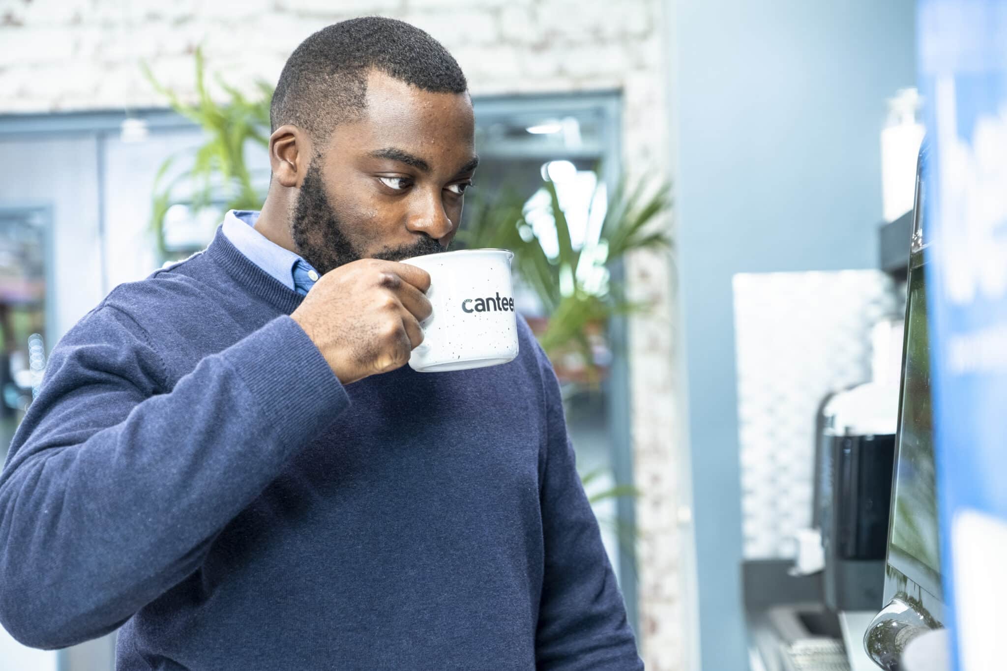 Man in office drinking Canteen coffee